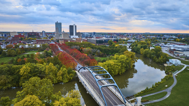 Aerial Golden Hour Urban Landscape with Bridge and Autumn Foliage