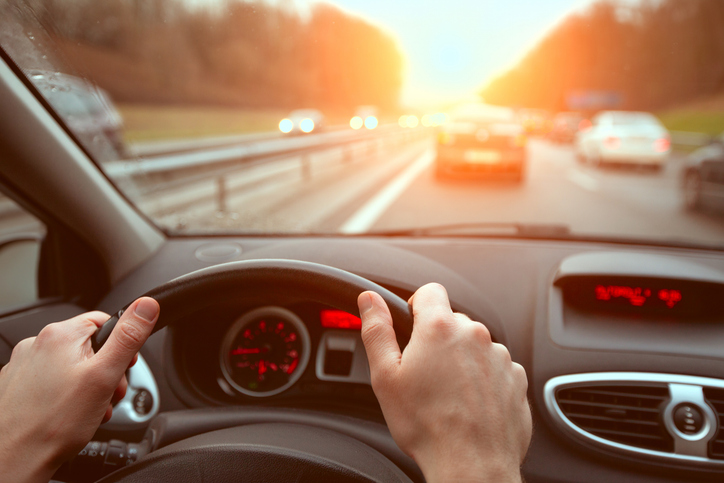 closeup hands of car driver on steering wheel